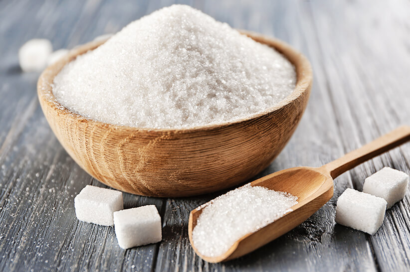 white sugar in a wooden bowl