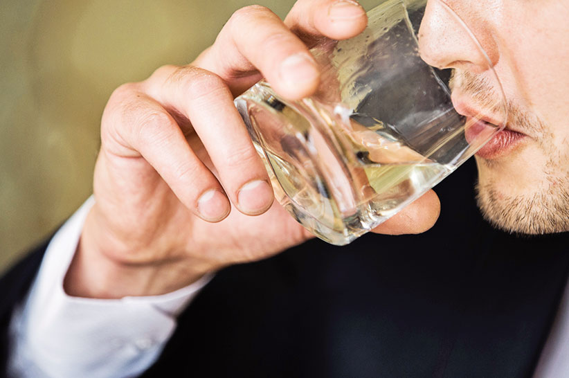 a man drinking hard liquor